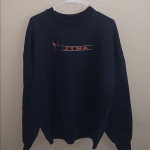Dark blue pull over that says “Utsa”
